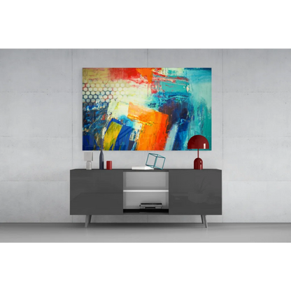Vibrant bold abstract canvas wall art with red, orange, blue, teal bursts above gray console