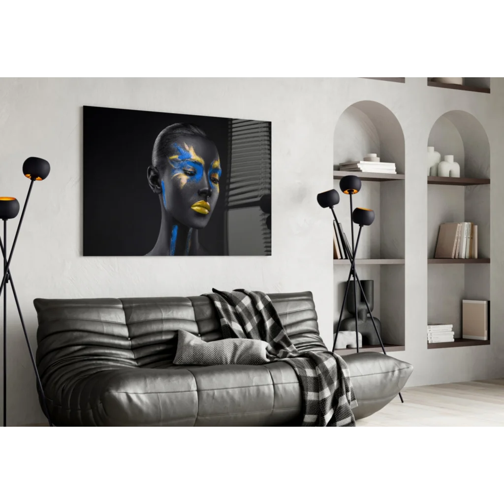 Black leather sofa with textured pattern and checkered throw blanket under bold abstract face paint wall art