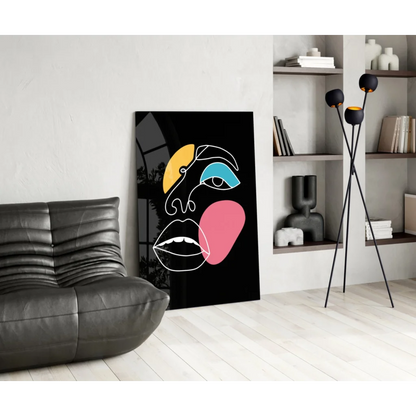 Bold geometric face glass wall art in vibrant yellow, blue, pink on black canvas