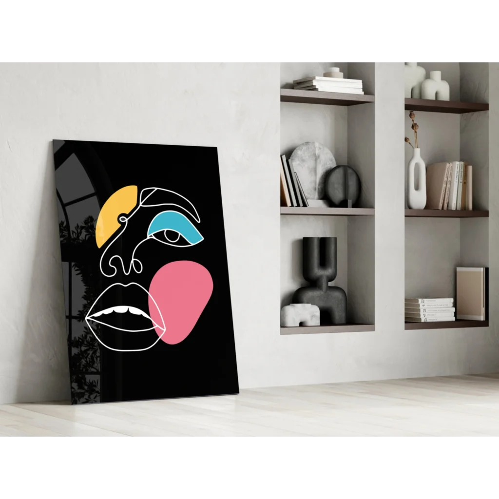 Bold geometric face glass wall art in vibrant yellow, blue, pink on black