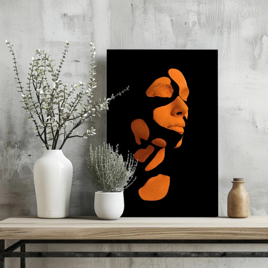 Bold orange abstract face art print on sleek black aluminum