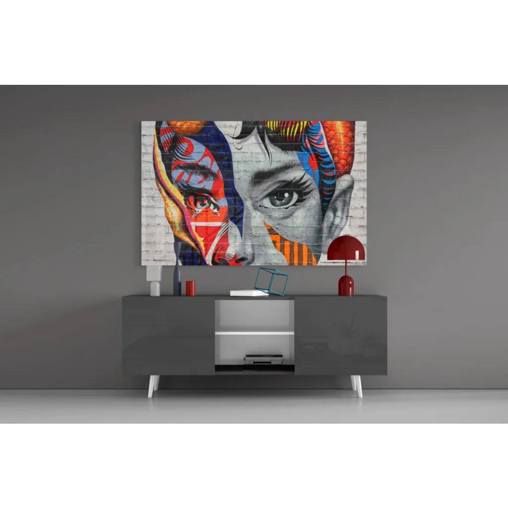Bold pop art face canvas wall art with vibrant red, blue, orange geometric patterns on textured white brick