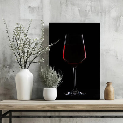 Black-framed canvas print of red wine glass on black background