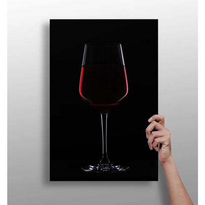 Sleek transparent wine glass with bold red wine on black background canvas print