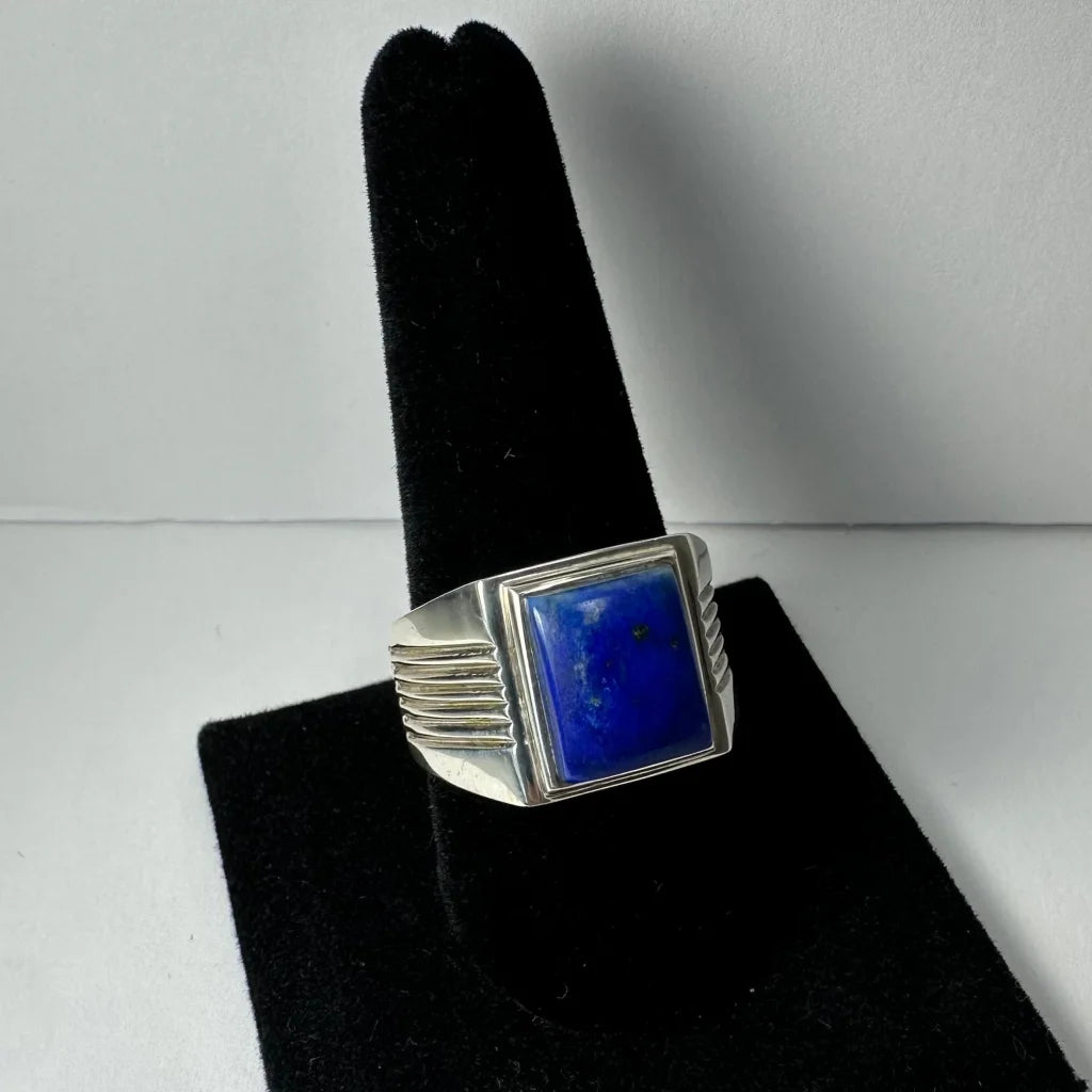 Bold silver lapis lazuli ring with grooved band and blue stone