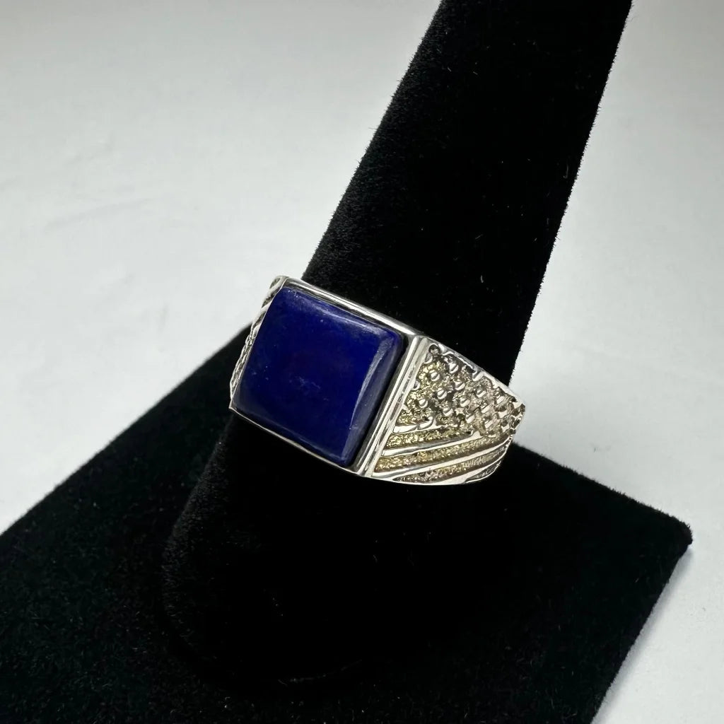 Bold sterling silver lapis lazuli ring with ornate textured band and deep blue stone