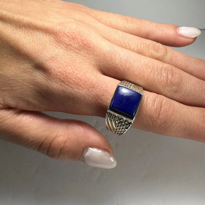 Bold silver lapis lazuli ring with deep blue stone and ornate band