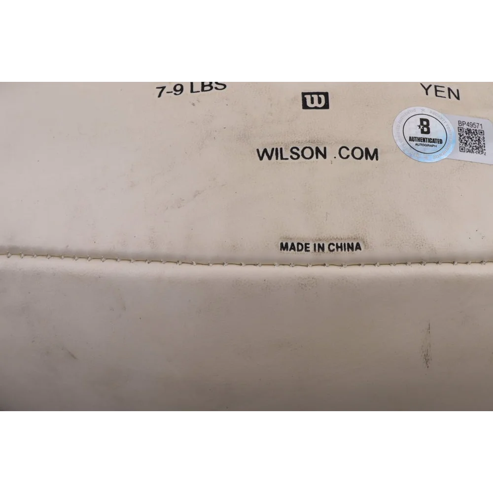 Close-up of white sports bag with black text and holographic Super Bowl XXXVII logo sticker