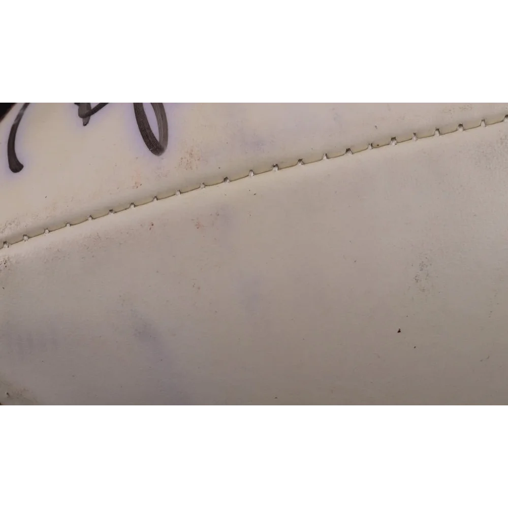 Smooth light surface with riveted seam on Boomer Esiason Michael Lewis Super Bowl XXXVII logo football