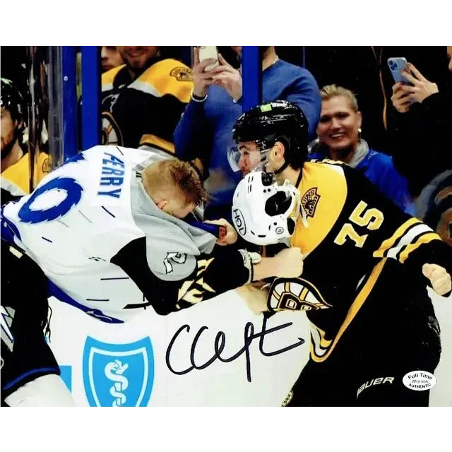 Autographed 8x10 photo of Boston Bruins players fighting with authentication card