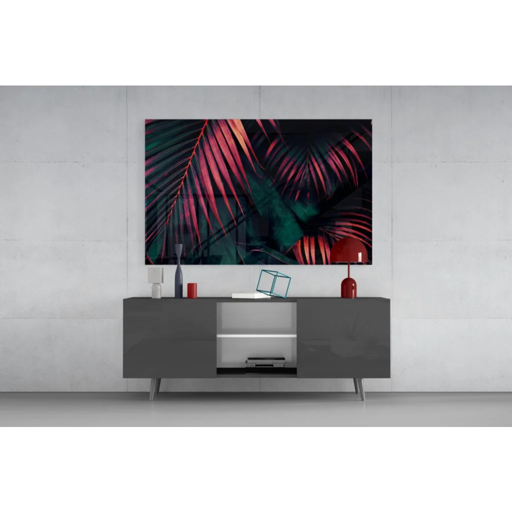 Vibrant tropical leaf glass wall art in magenta and teal on gray console