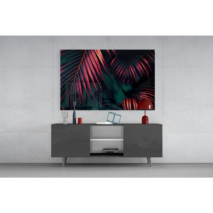 Vibrant tropical leaf glass wall art in magenta and teal on gray console