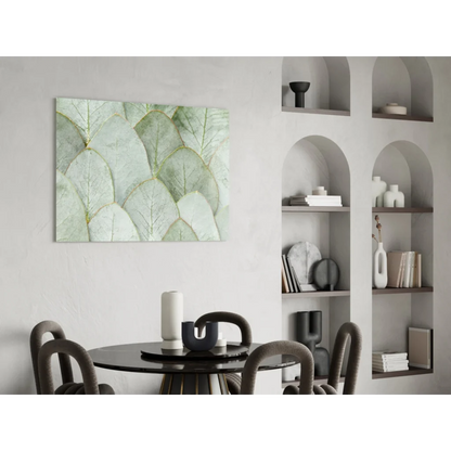 Stunning glass wall art of overlapping light green leaves with gold veining on white wall