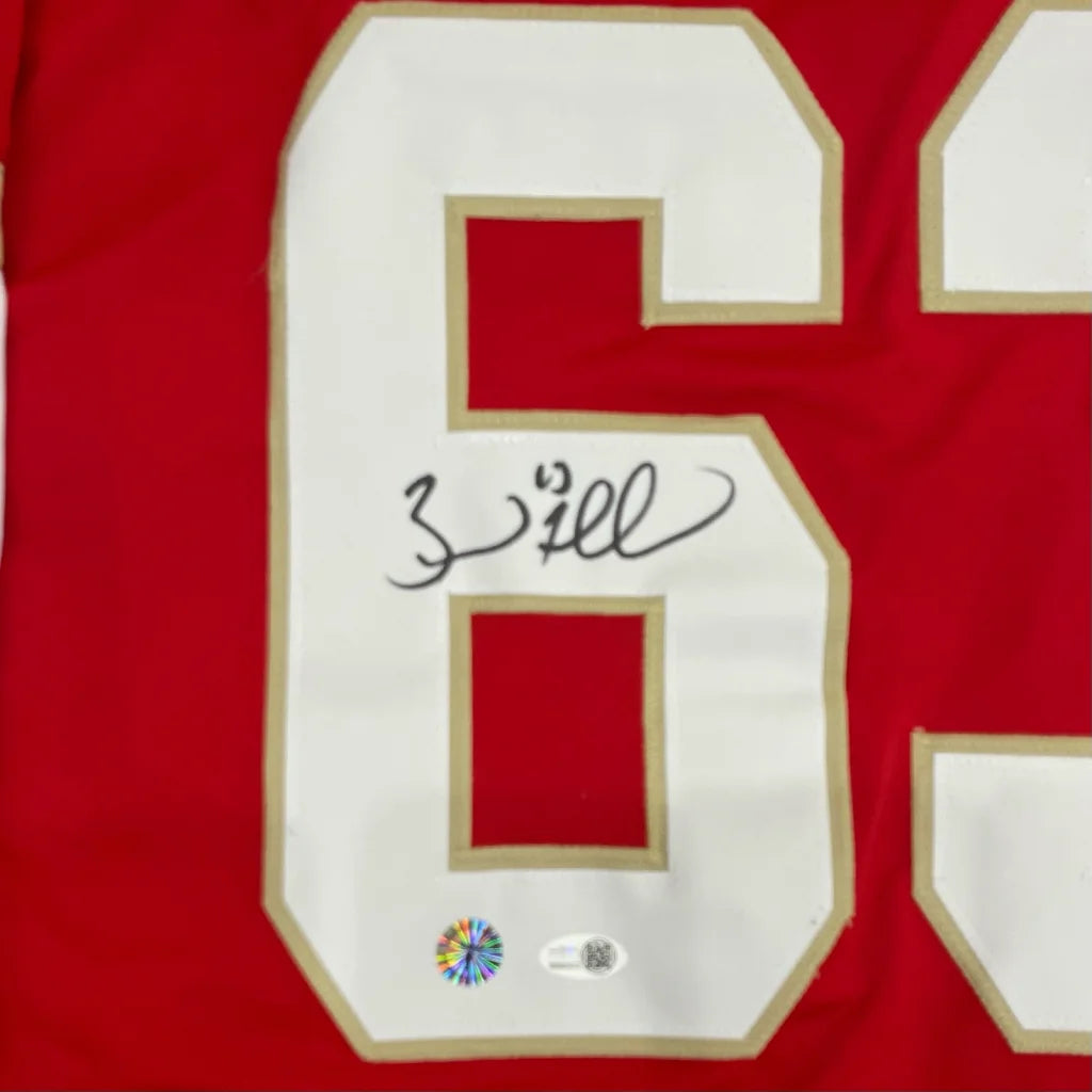 Red custom sports jersey featuring brad marchand autograph with white number 6 outlined in gold and jsa authentication stickers
