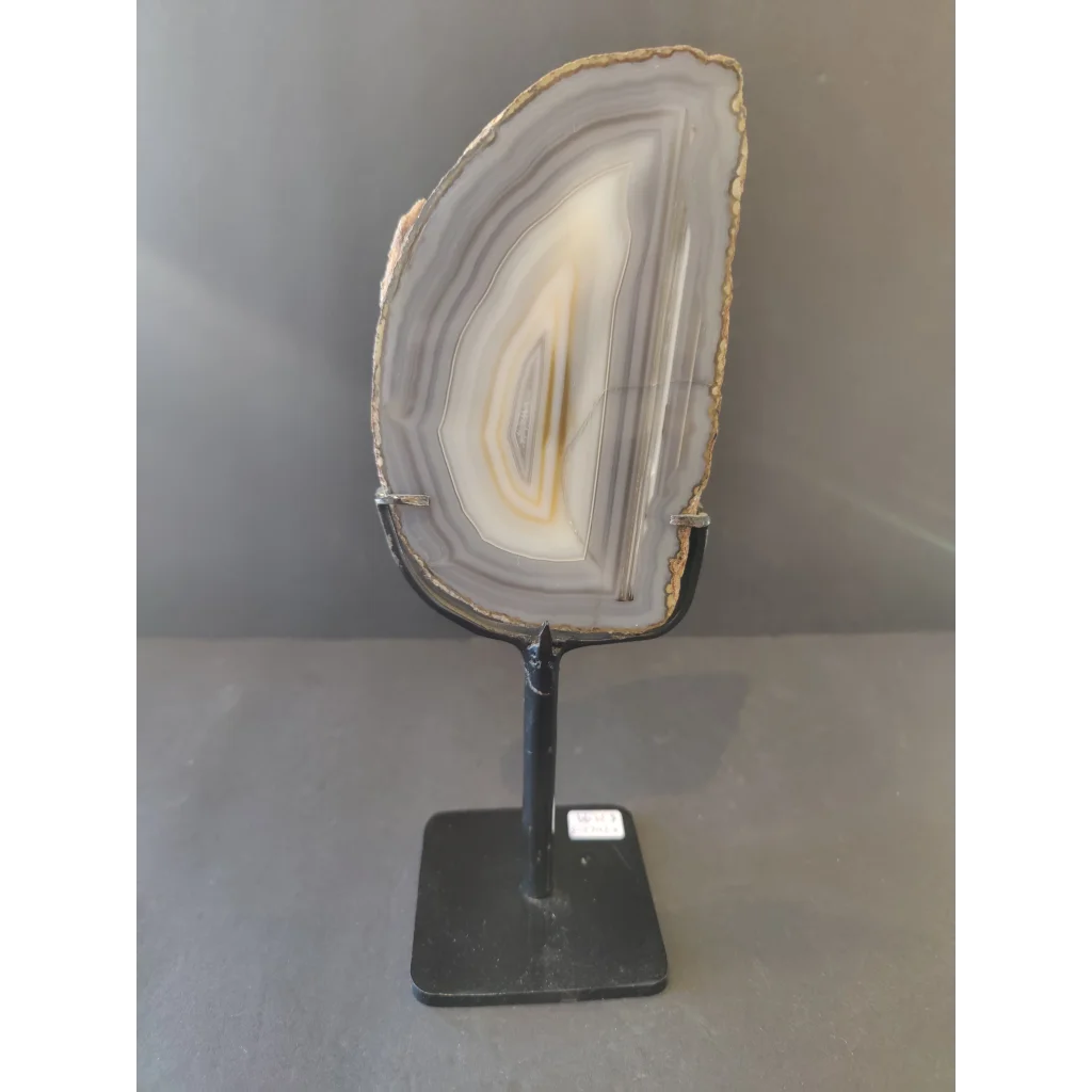 Polished gray and white Brazilian agate slice on metal display stand