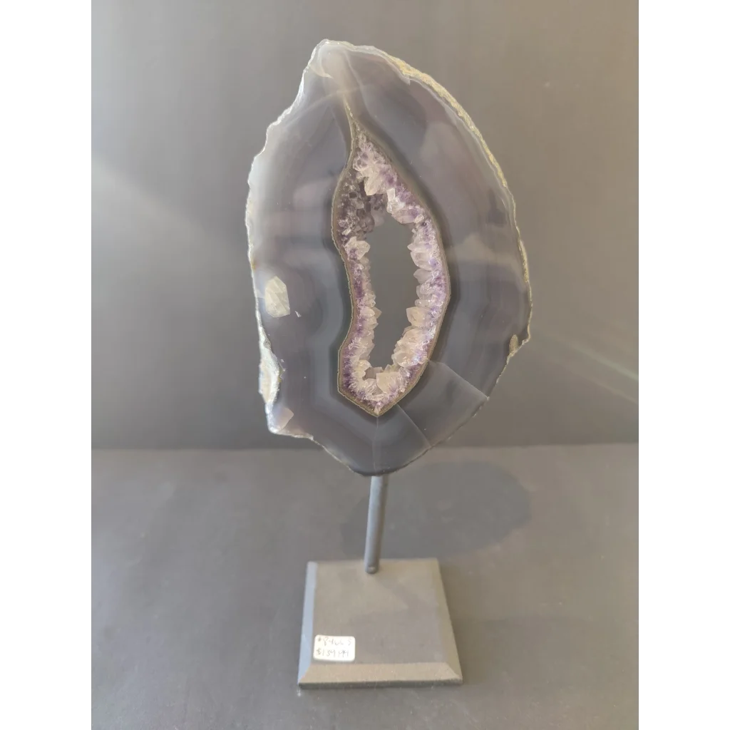 Polished gray and purple Brazilian agate slice on metal display stand