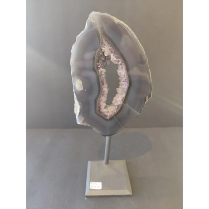 Polished gray and purple Brazilian agate slice on metal display stand