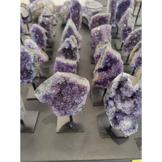 Purple Brazilian amethyst geode on black metal stand