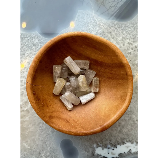 Brazilian golden rutilated quartz crystal points in wooden bowl