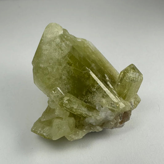 Translucent yellow-green Brazilianite specimen with sharp crystalline facets