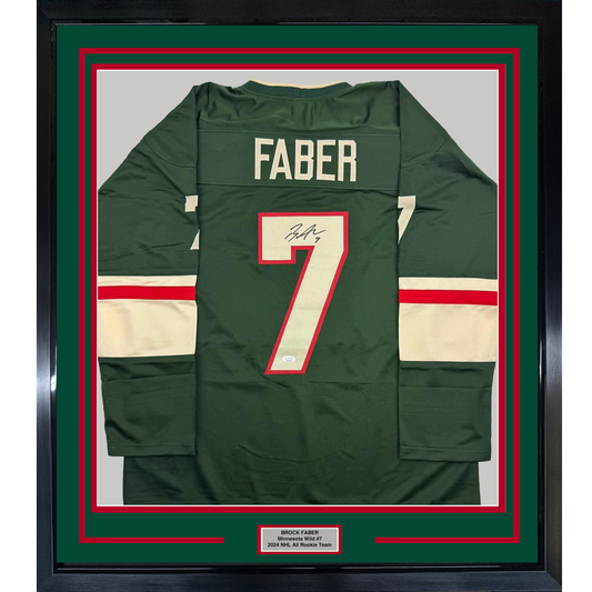 Framed dark green hockey jersey with "FABER" and number 7 displayed flat, featuring red and cream horizontal stripes and an autographed nameplate below.