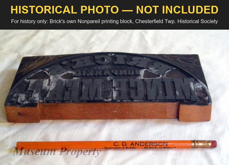 Brick's own Nonpareil Mince Meat printing block, a reversed metal face on a wooden base beside a pencil for scale; Chesterfield Township Historical Society photo, for history only, not included.