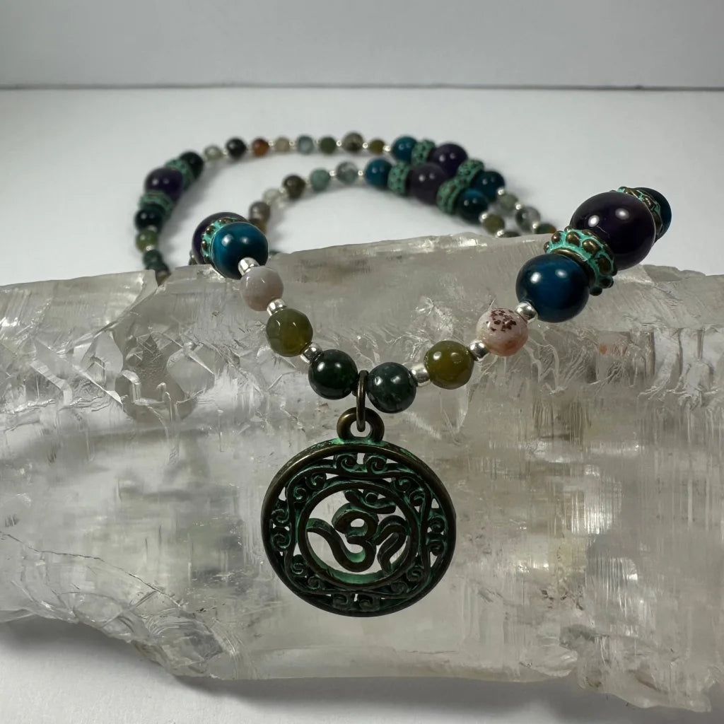 Dark green patina Om pendant necklace with bronze patina and blue tiger eye beads