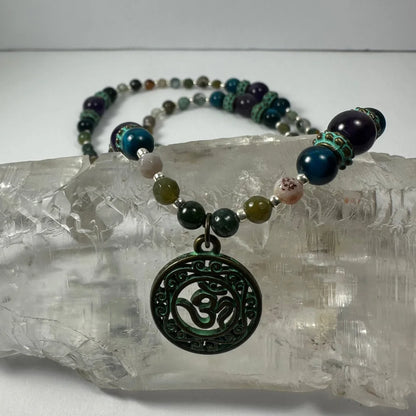 Dark green patina Om pendant necklace with bronze patina and blue tiger eye beads