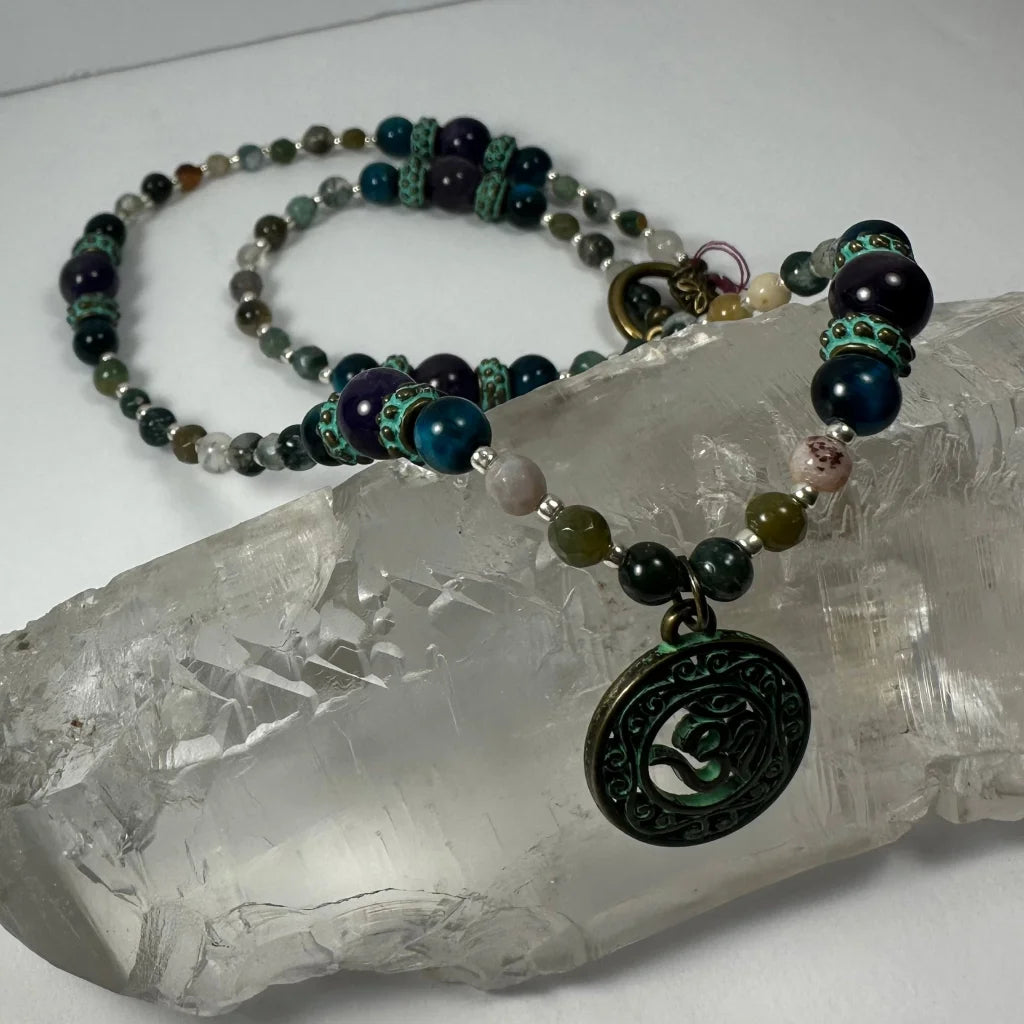 Bronze patina om pendant necklace with teal beads and gemstones