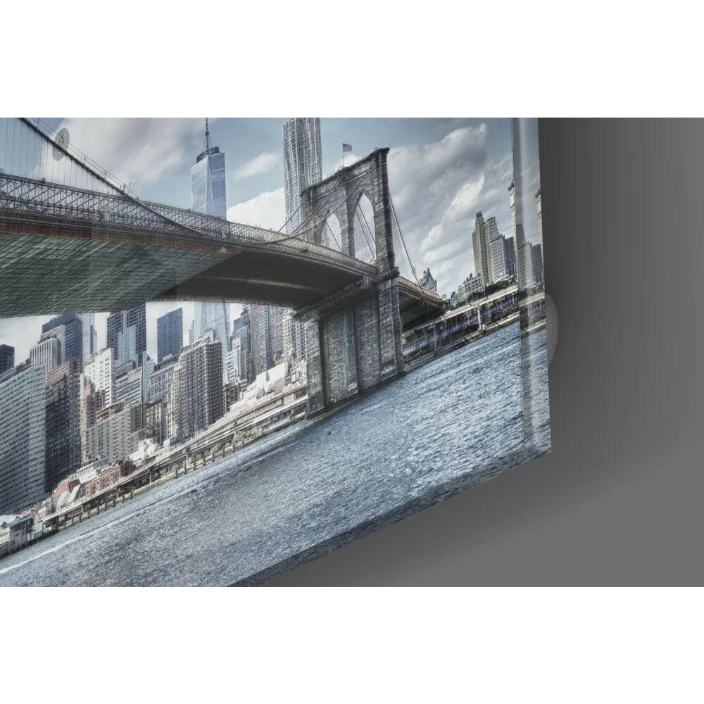 Brooklyn Bridge glass wall art with NYC skyline in cool blue tones