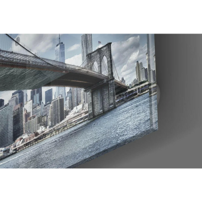 Brooklyn Bridge glass wall art with NYC skyline in cool blue tones