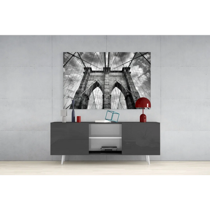 Black-and-white Brooklyn Bridge glass wall art on gray wall