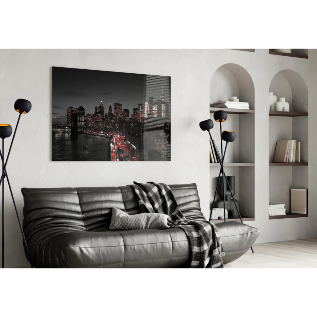 Black leather sofa with plaid throw and Brooklyn Bridge wall art