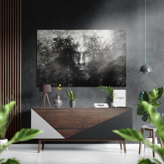 Modern interior styling scene showing black and white portrait artwork displayed above wooden dresser with plants and decor.