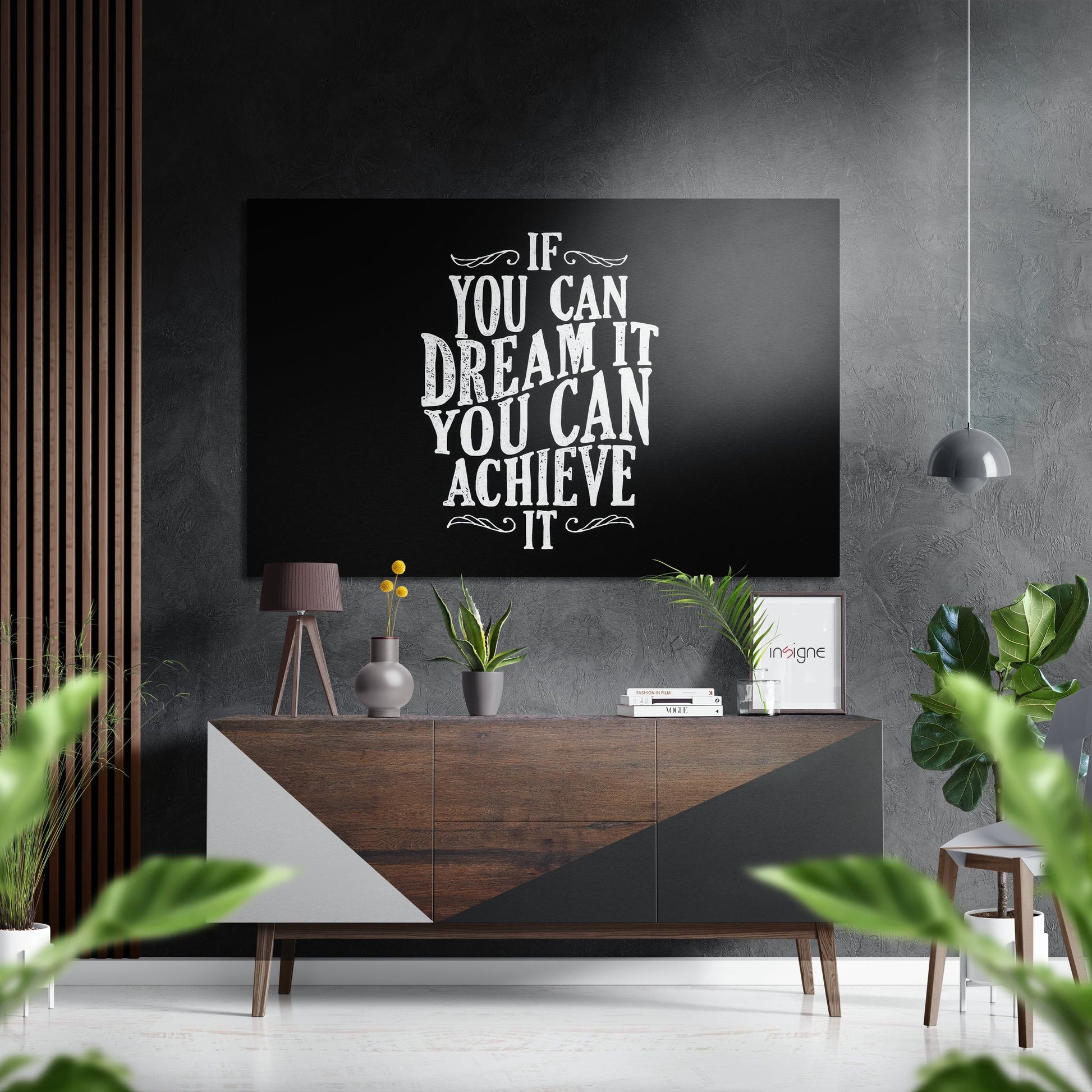 Modern living room with motivational quote "If You Can Dream It You Can Achieve It" displayed on black wall art above wooden console table.
