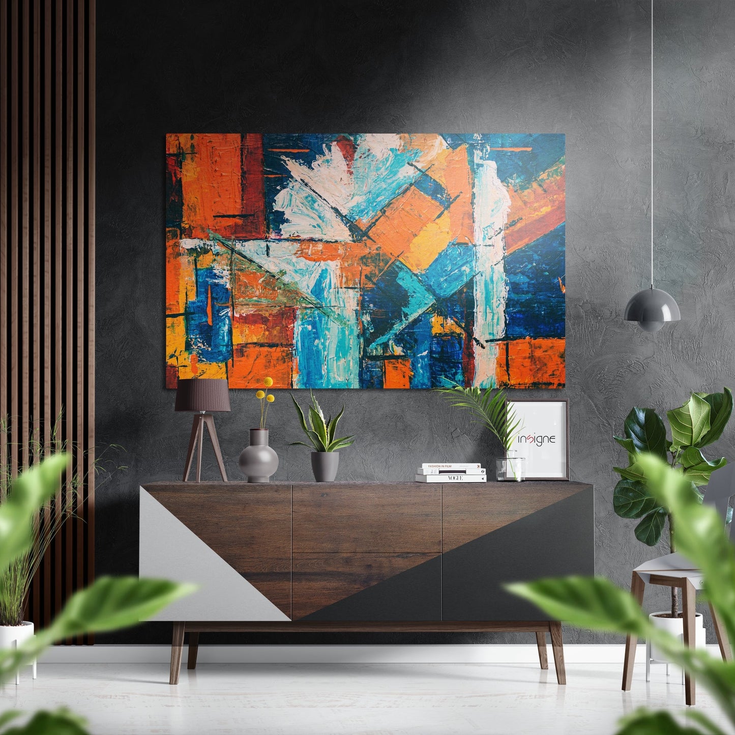 Modern living room interior with colorful abstract brushed aluminium wall art featuring orange, blue, and yellow blocks displayed above wooden sideboard.