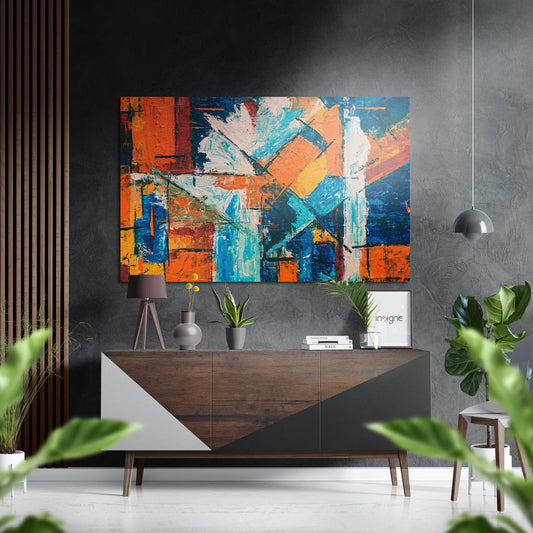 Modern living room interior with colorful abstract brushed aluminium wall art featuring orange, blue, and yellow blocks displayed above wooden sideboard.