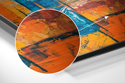 Close-up detail of brushed aluminium surface showing orange, red, and blue paint strokes with wood grain texture and visible brush marks.