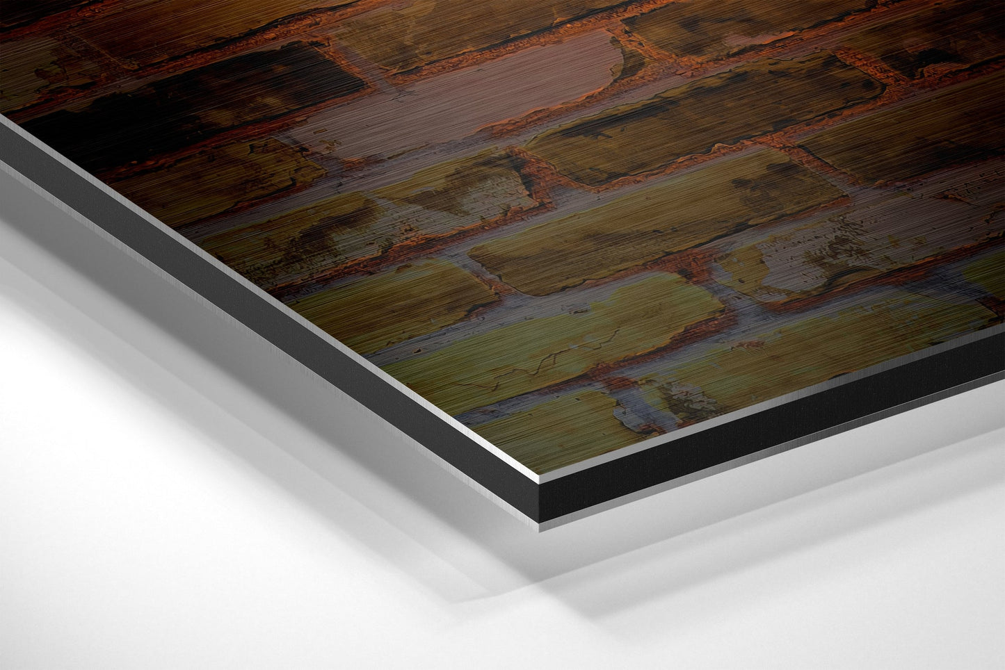 Close-up angled view of layered Dibond mounting showing rustic wood print surface with dark borders and metallic edges.