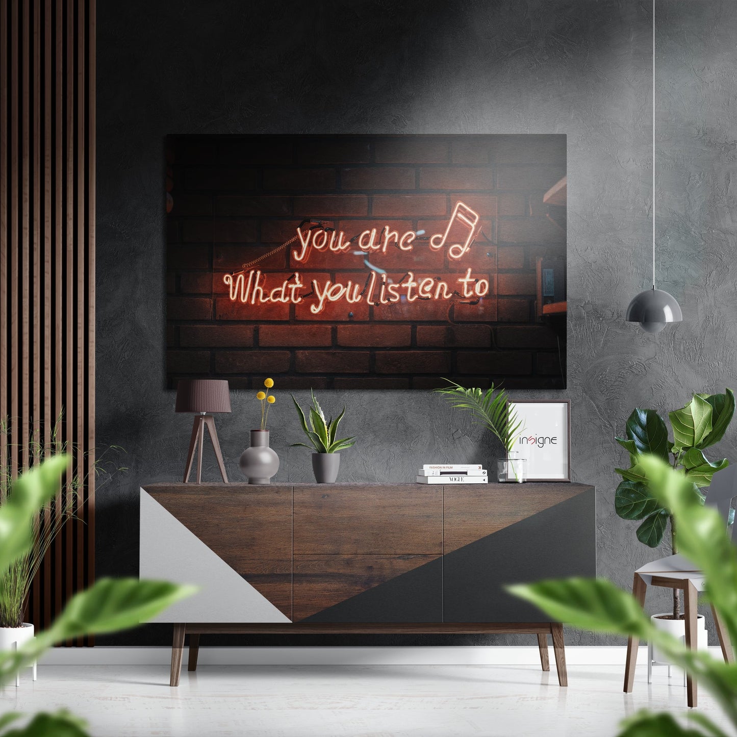 Modern living room with neon sign reading "you are what you listen to" mounted above wooden console table with plants and decor.