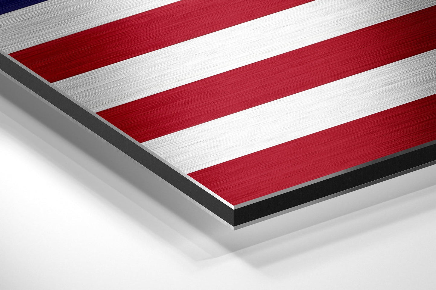 Angled close-up view of brushed aluminum dibond wall art displaying red and white horizontal stripes with dark edges.