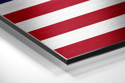 Angled close-up view of brushed aluminum dibond wall art displaying red and white horizontal stripes with dark edges.