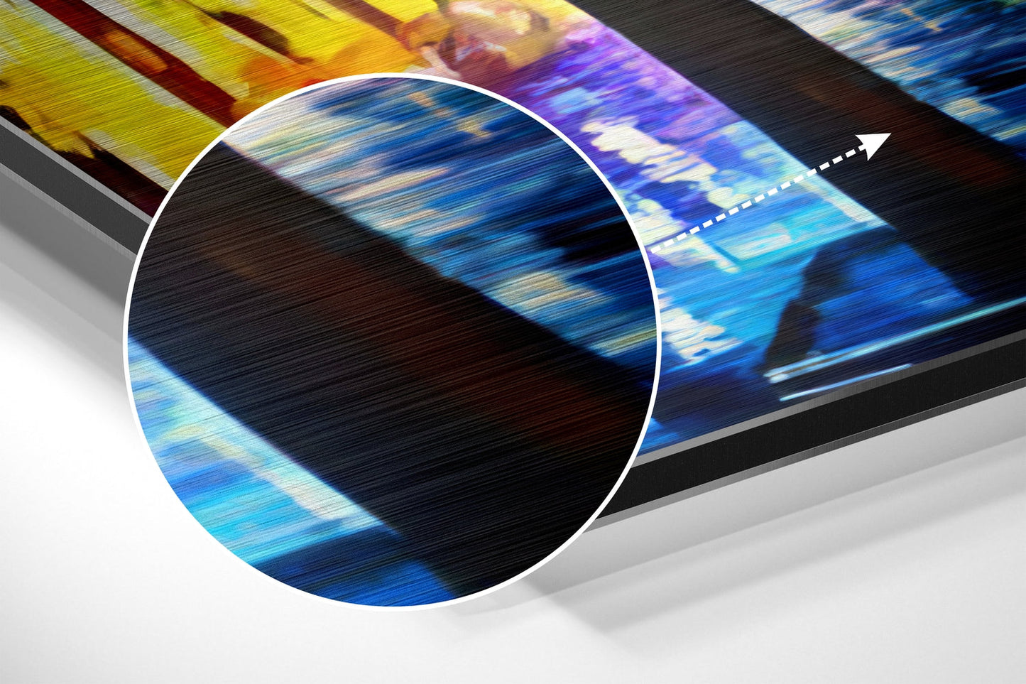 Close-up circular magnification of brushed aluminum surface showing blue, yellow, and purple light streaks with motion blur effect and directional arrow.