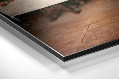 Close-up angled view of brushed aluminum and black edge framing of Last Supper wall art print.