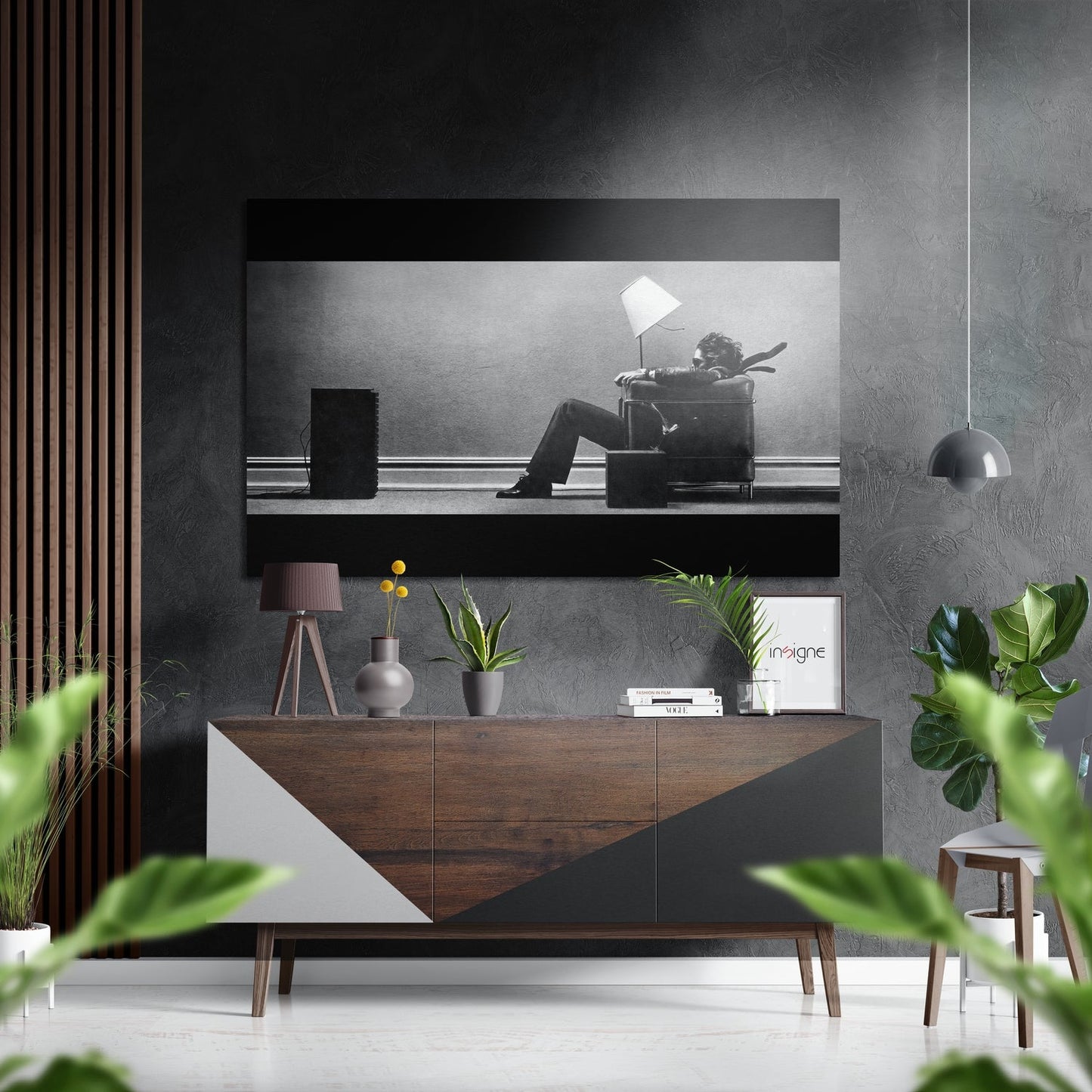 Black and white Dibond wall art depicting silhouetted figure with lamp on shelf, displayed above wooden dresser in modern interior.