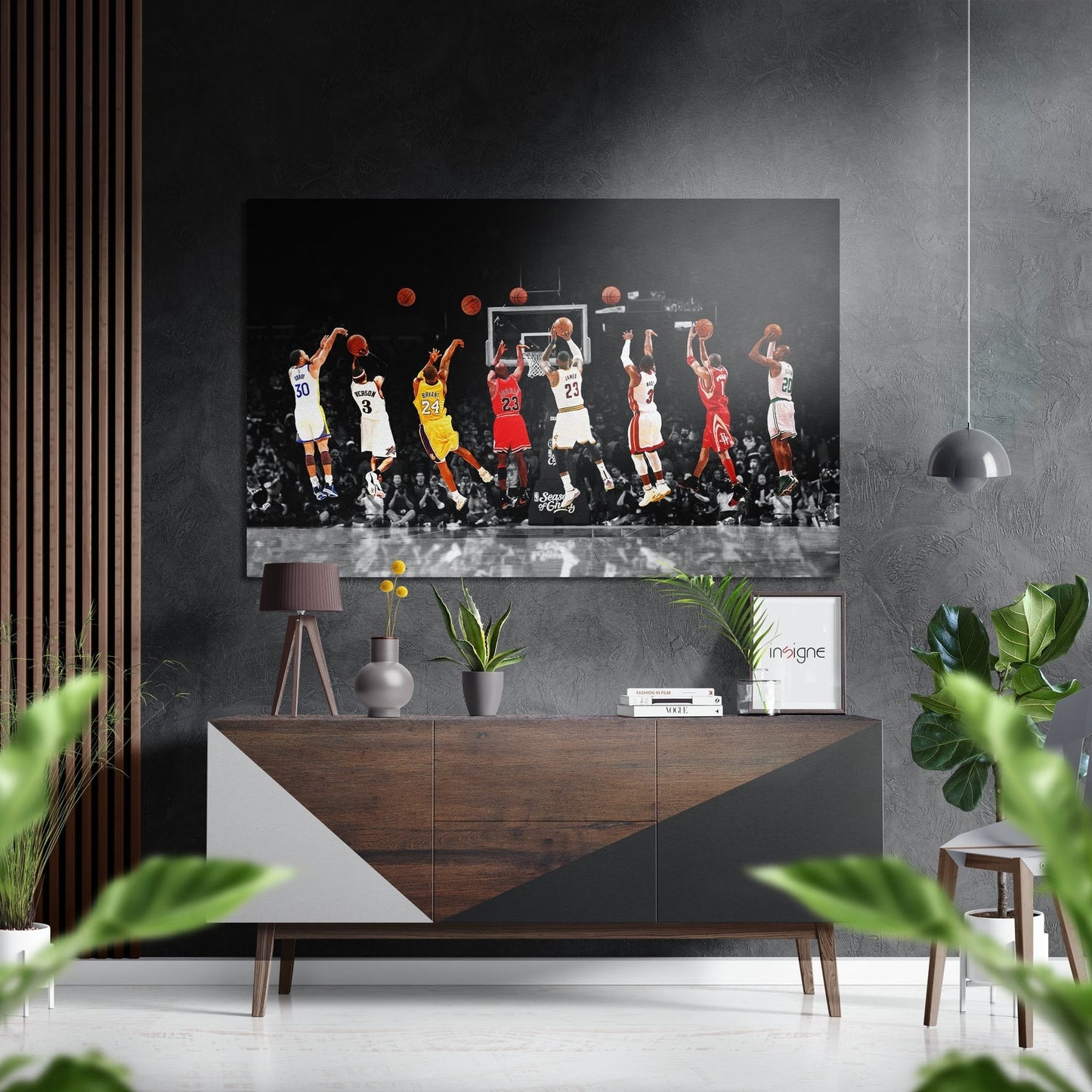 Modern living room with basketball players aluminum wall art mounted above wooden console, flanked by potted plants and decorative items.