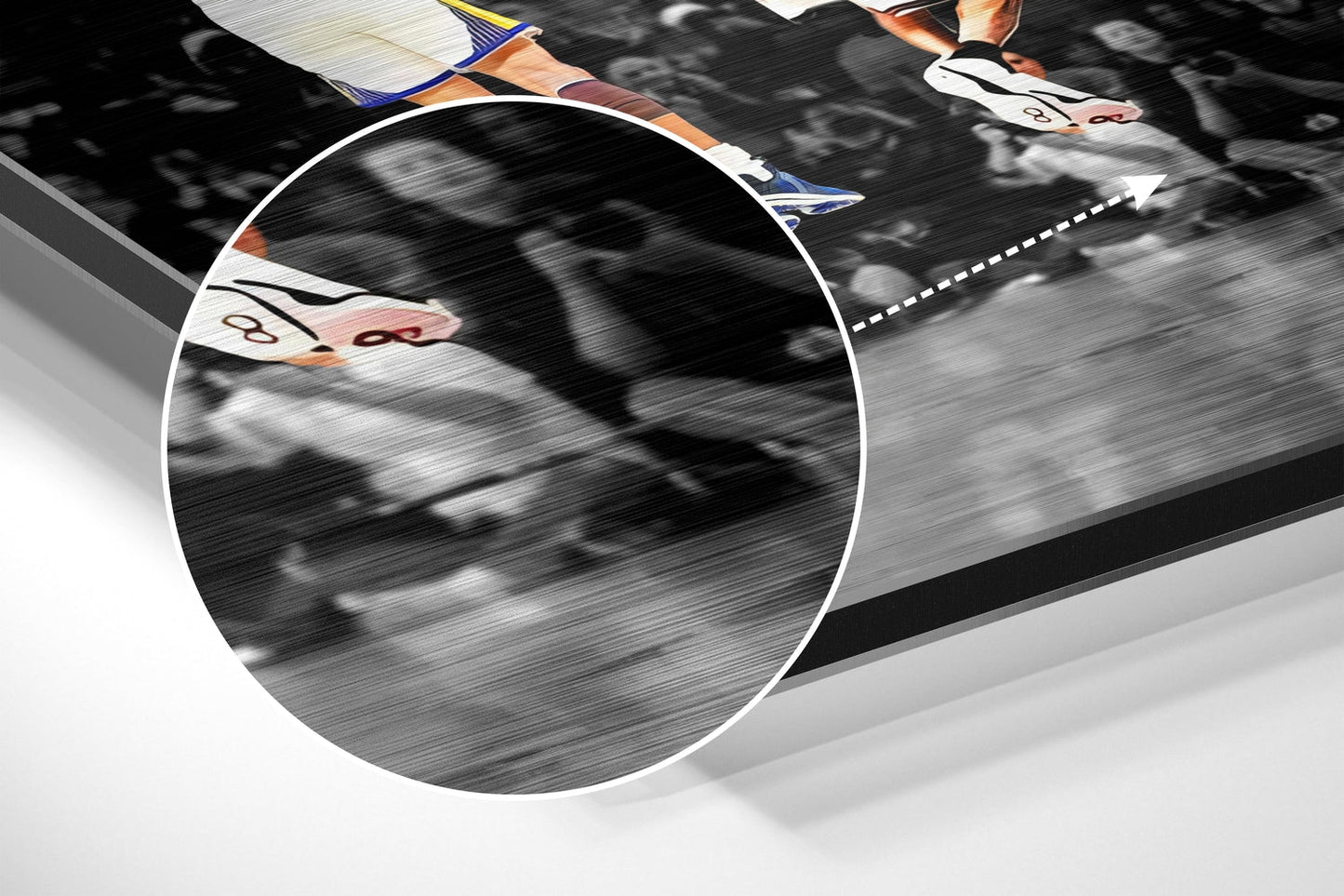 Close-up detail of brushed aluminum wall art showing athlete's feet in colored sneakers with motion blur and white dashed line on dark background.