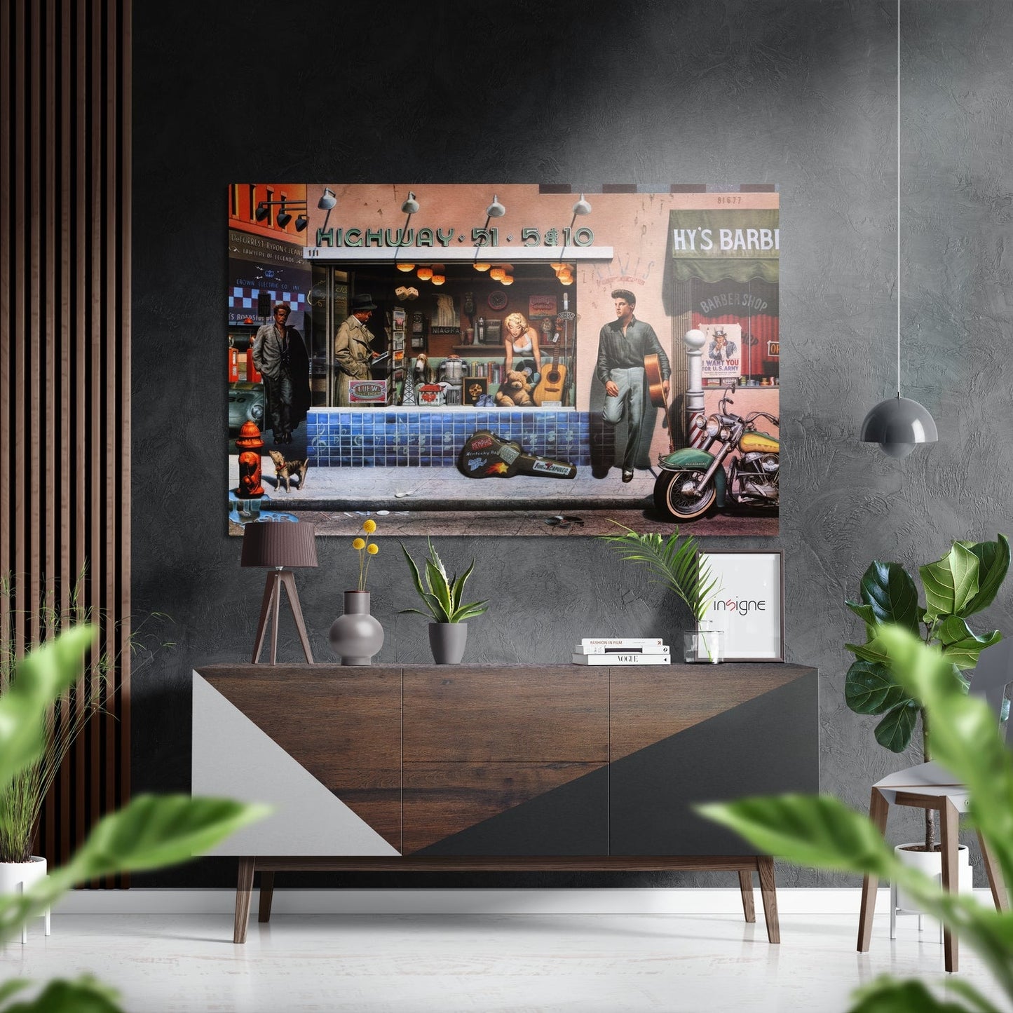 Retro street scene wall art mounted above wooden dresser in modern living room with plants and pendant light visible.
