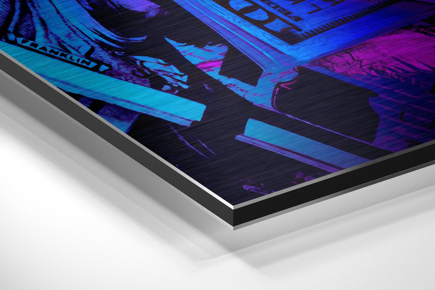 Close-up angled view of brushed aluminium Dibond wall art with neon blue and purple digital artwork on black background.