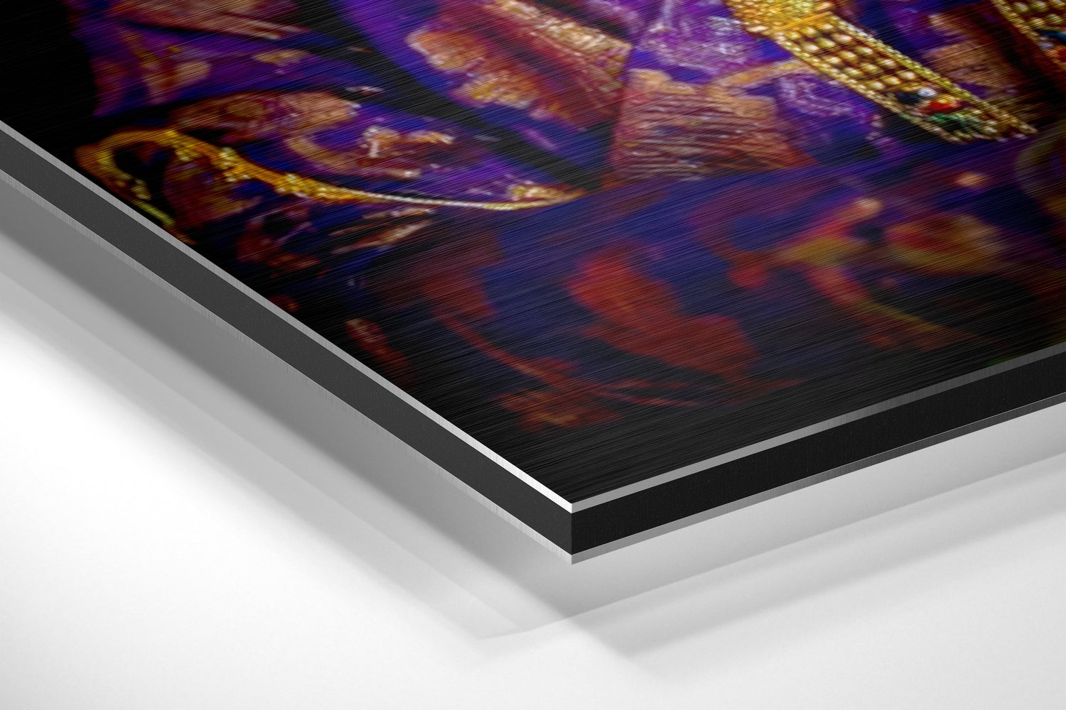 Angled perspective view of Krishna brushed aluminium Dibond wall art showing layered edges and vibrant purple, gold, and red decorative print.